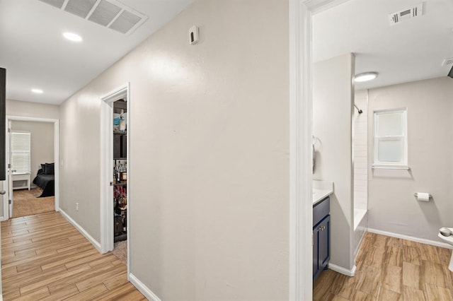 104 N Ramblin Oaks Dr, Moore, OK 73160 - hallway featuring light wood-style floors and baseboards