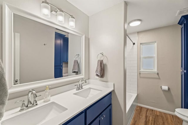 104 N Ramblin Oaks Dr, Moore, OK 73160 - full bathroom with wood finished floors, double vanity, and shower / washtub combination