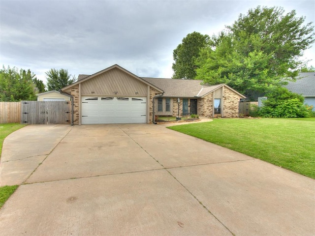 6708 Basswood Canyon Rd, Oklahoma City, OK 73162 - view of front facade featuring an attached garage, driveway, brick siding, a gate, and board and batten siding