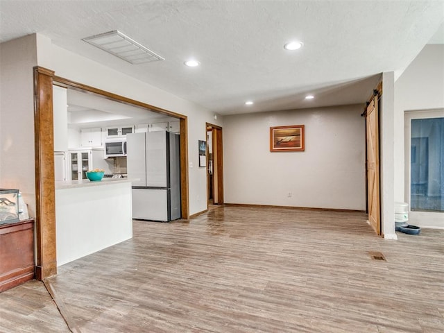 6708 Basswood Canyon Rd, Oklahoma City, OK 73162 - unfurnished living room featuring light wood-type flooring and recessed lighting