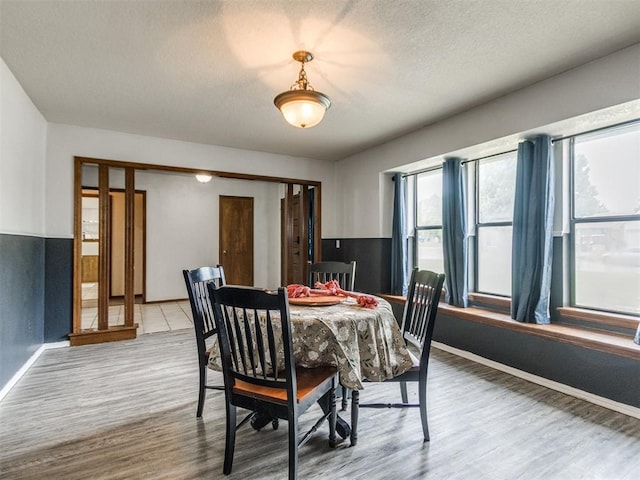 6708 Basswood Canyon Rd, Oklahoma City, OK 73162 - dining area featuring wood finished floors and a textured ceiling
