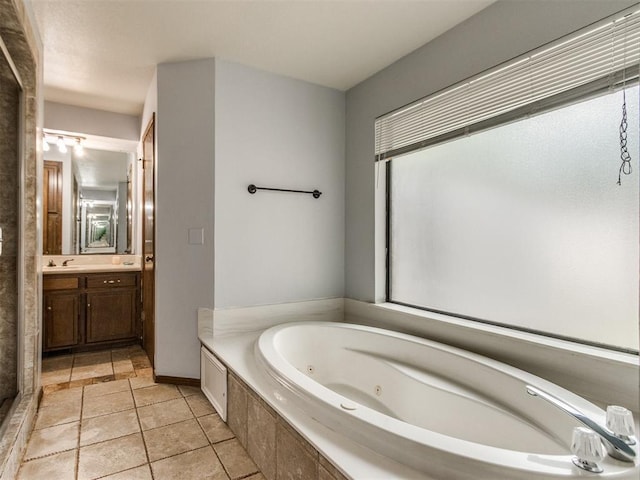 6708 Basswood Canyon Rd, Oklahoma City, OK 73162 - full bath featuring a jetted tub, vanity, and tile patterned floors