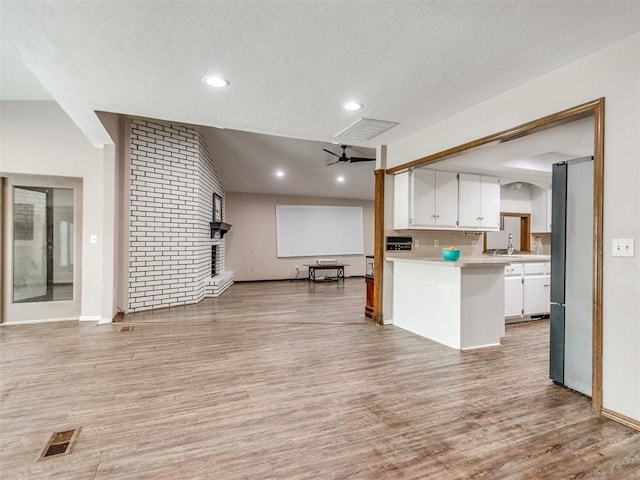 6708 Basswood Canyon Rd, Oklahoma City, OK 73162 - kitchen featuring open floor plan, white cabinetry, light wood-type flooring, light countertops, and recessed lighting