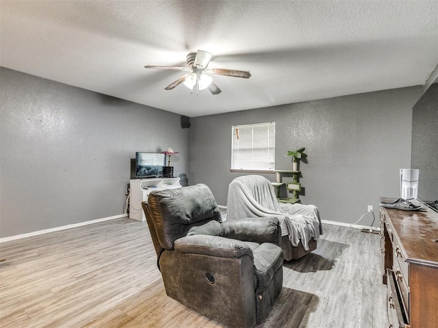 6708 Basswood Canyon Rd, Oklahoma City, OK 73162 - living area with a ceiling fan, light wood-type flooring, a textured wall, and a textured ceiling
