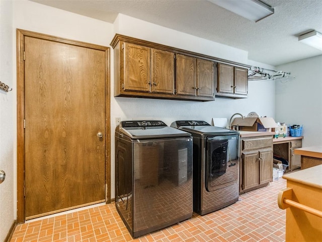 6708 Basswood Canyon Rd, Oklahoma City, OK 73162 - laundry room with washer and dryer, brick patterned floors, cabinet space, and a textured ceiling