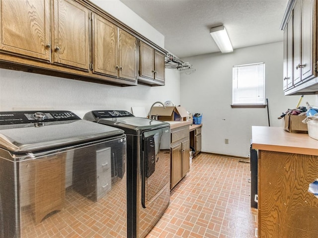 6708 Basswood Canyon Rd, Oklahoma City, OK 73162 - laundry area featuring washer and clothes dryer, brick patterned floors, and cabinet space