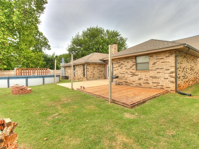 6708 Basswood Canyon Rd, Oklahoma City, OK 73162 - view of yard with a wooden deck and an outdoor pool