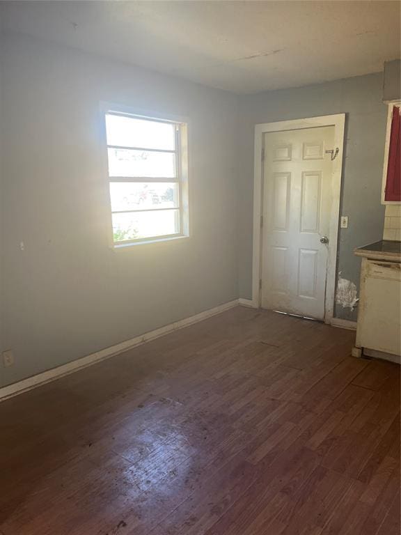 505 S Jackson Ave, Blanchard, OK 73010 - unfurnished room with dark wood-style flooring and baseboards