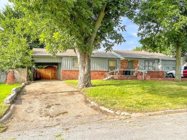 6112 NW 49th St, Warr Acres, OK 73122 - ranch-style house with brick siding, driveway, roof with shingles, and an attached carport