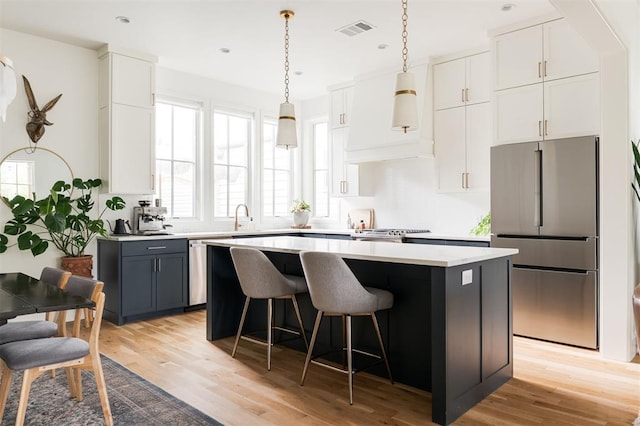 1900 Runway Blvd, Oklahoma City, OK 73108 - kitchen with stainless steel appliances, a kitchen island, light countertops, light wood-style floors, and a breakfast bar