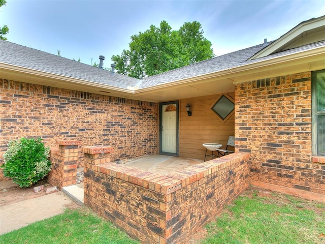 1221 Val Genes Rd, Edmond, OK 73003 - entrance to property featuring a shingled roof and brick siding