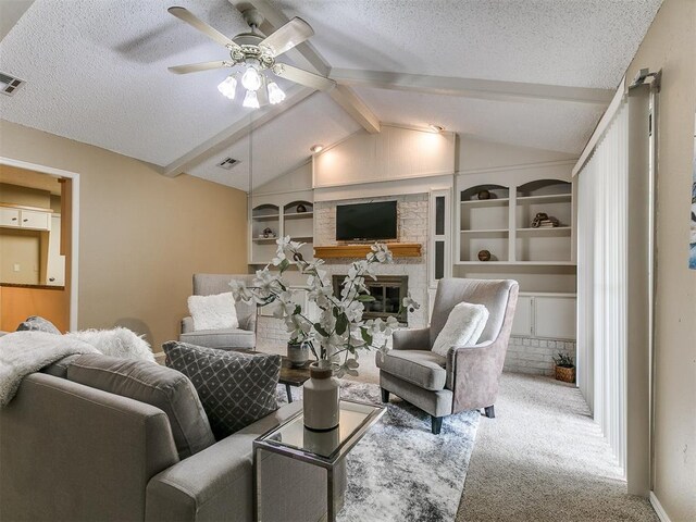 1221 Val Genes Rd, Edmond, OK 73003 - carpeted living area with ceiling fan, a textured ceiling, a stone fireplace, and built in shelves
