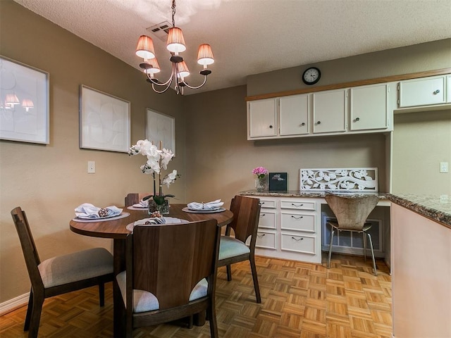 1221 Val Genes Rd, Edmond, OK 73003 - dining space with built in study area, a chandelier, and a textured ceiling