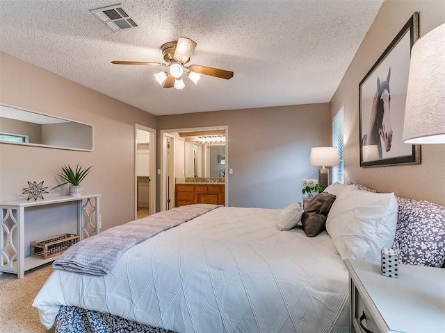 1221 Val Genes Rd, Edmond, OK 73003 - carpeted bedroom with a textured ceiling, ceiling fan, and connected bathroom