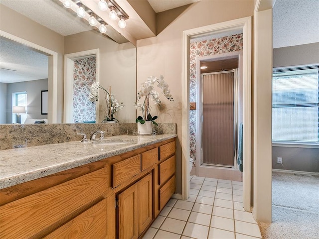 1221 Val Genes Rd, Edmond, OK 73003 - full bathroom featuring vanity, a stall shower, plenty of natural light, and a textured ceiling
