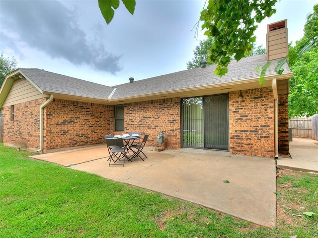 1221 Val Genes Rd, Edmond, OK 73003 - back of house featuring brick siding, a patio, a chimney, and a shingled roof