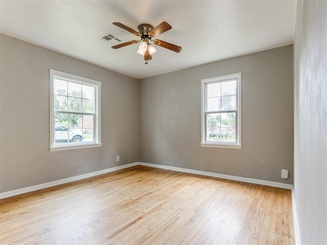 1125 E Fay St, Shawnee, OK 74801 - unfurnished room featuring plenty of natural light, hardwood / wood-style floors, and a ceiling fan