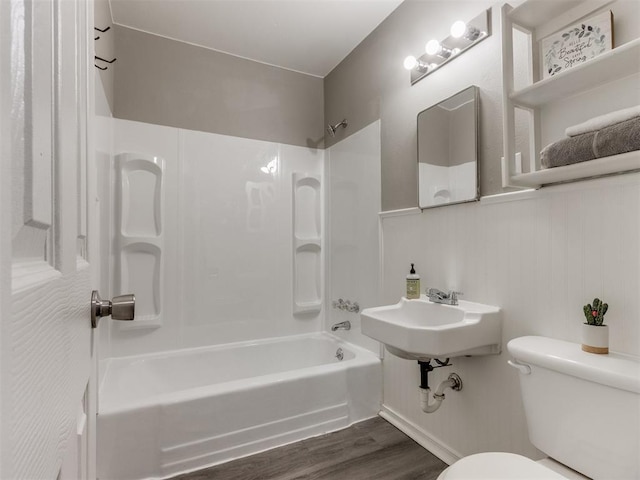 1125 E Fay St, Shawnee, OK 74801 - bathroom with bathing tub / shower combination, wood finished floors, and a wainscoted wall