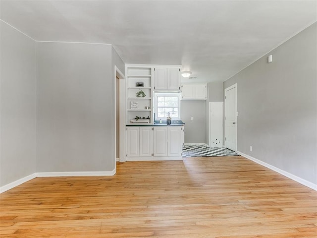 1125 E Fay St, Shawnee, OK 74801 - unfurnished living room with light wood-type flooring and baseboards