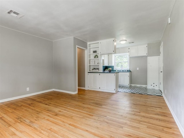 1125 E Fay St, Shawnee, OK 74801 - unfurnished living room with light wood-type flooring and baseboards