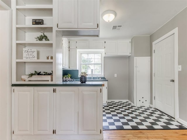 1125 E Fay St, Shawnee, OK 74801 - kitchen with tile patterned floors, open shelves, white cabinetry, and dark countertops