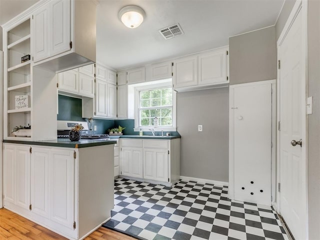 1125 E Fay St, Shawnee, OK 74801 - kitchen featuring light floors, dark countertops, white cabinets, and open shelves
