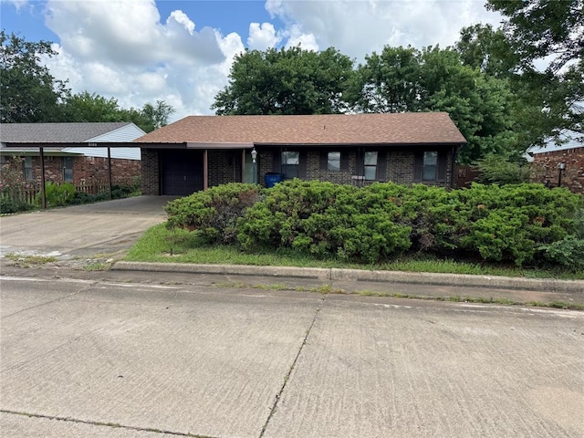 1217 Dove Hollow Dr, Tecumseh, OK 74873 - ranch-style house featuring a garage, brick siding, and concrete driveway