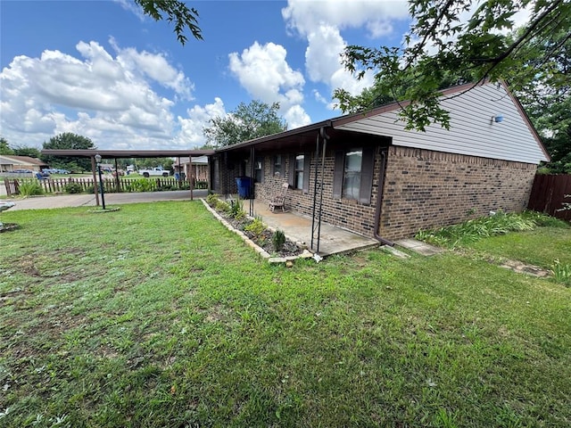 1217 Dove Hollow Dr, Tecumseh, OK 74873 - view of side of property featuring brick siding and a patio