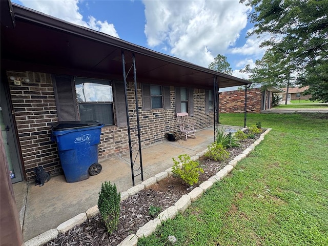 1217 Dove Hollow Dr, Tecumseh, OK 74873 - view of side of home with a yard and brick siding