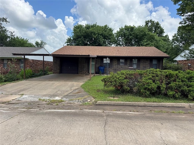 1217 Dove Hollow Dr, Tecumseh, OK 74873 - ranch-style house featuring a garage, brick siding, and driveway