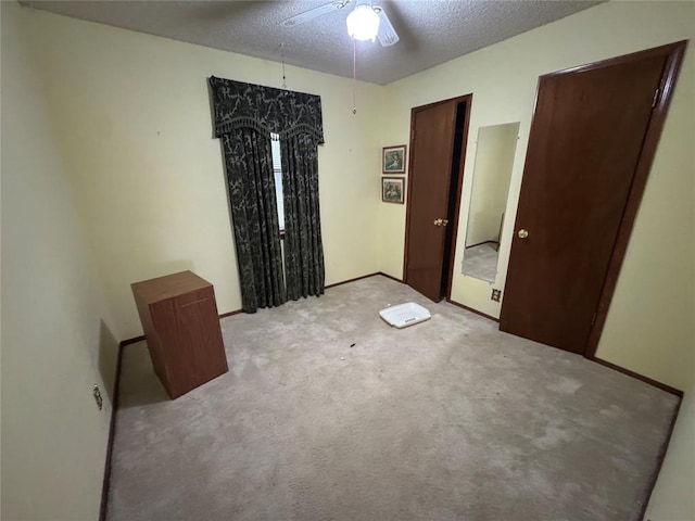 1217 Dove Hollow Dr, Tecumseh, OK 74873 - unfurnished bedroom with light carpet, a textured ceiling, and ceiling fan