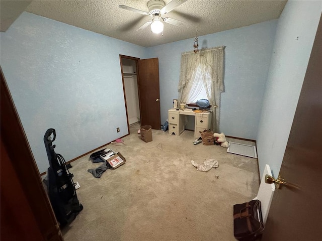 1217 Dove Hollow Dr, Tecumseh, OK 74873 - unfurnished bedroom with a textured ceiling, carpet flooring, and ceiling fan