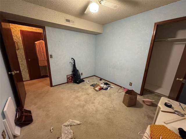 1217 Dove Hollow Dr, Tecumseh, OK 74873 - unfurnished bedroom featuring carpet, a textured ceiling, ceiling fan, and a closet