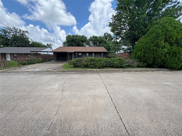 1217 Dove Hollow Dr, Tecumseh, OK 74873 - view of front of property featuring an attached garage, driveway, and brick siding