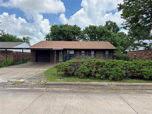 1217 Dove Hollow Dr, Tecumseh, OK 74873 - single story home featuring a garage, brick siding, and concrete driveway