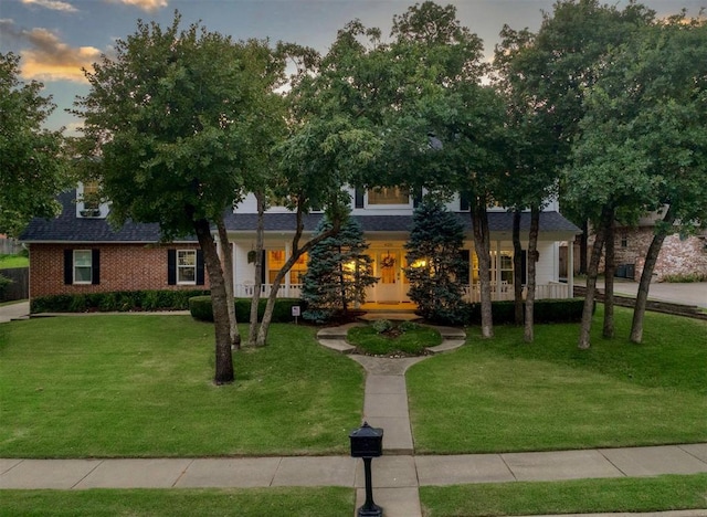 4201 Echohollow Trl, Edmond, OK 73025 - view of front of home featuring a yard, a porch, and a shingled roof