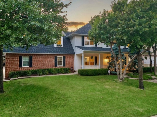 4201 Echohollow Trl, Edmond, OK 73025 - view of front of property featuring covered porch, a yard, roof with shingles, and brick siding