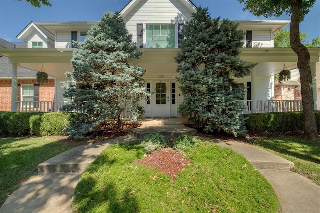 4201 Echohollow Trl, Edmond, OK 73025 - view of front of home featuring covered porch and a front lawn