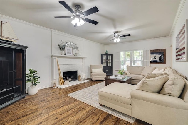 4201 Echohollow Trl, Edmond, OK 73025 - living room featuring ceiling fan, wood finished floors, a fireplace, and crown molding