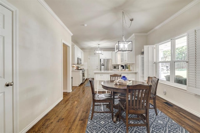 4201 Echohollow Trl, Edmond, OK 73025 - dining room with ornamental molding, dark wood-style flooring, and a chandelier