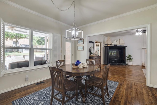 4201 Echohollow Trl, Edmond, OK 73025 - dining area featuring crown molding, ceiling fan, dark wood finished floors, and a chandelier