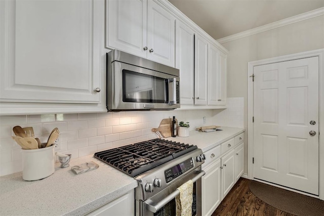 4201 Echohollow Trl, Edmond, OK 73025 - kitchen featuring stainless steel appliances, crown molding, white cabinets, backsplash, and dark wood-type flooring