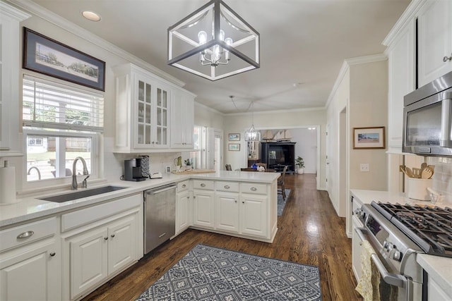 4201 Echohollow Trl, Edmond, OK 73025 - kitchen featuring stainless steel appliances, a chandelier, a peninsula, dark wood-type flooring, and glass insert cabinets