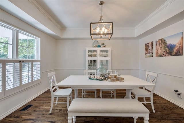 4201 Echohollow Trl, Edmond, OK 73025 - dining space with a chandelier, dark wood-style floors, crown molding, and a tray ceiling