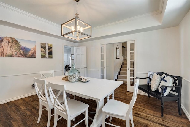 4201 Echohollow Trl, Edmond, OK 73025 - dining room with a chandelier, dark wood finished floors, ornamental molding, stairs, and a tray ceiling