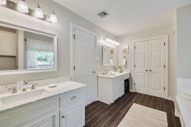 4201 Echohollow Trl, Edmond, OK 73025 - full bath featuring two vanities and wood tiled floors