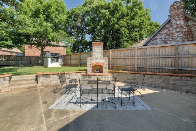 4201 Echohollow Trl, Edmond, OK 73025 - fenced backyard featuring an outdoor stone fireplace, a patio area, and a storage shed