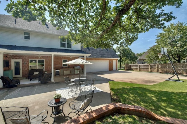 4201 Echohollow Trl, Edmond, OK 73025 - rear view of house with brick siding, a patio, roof with shingles, and an outdoor kitchen