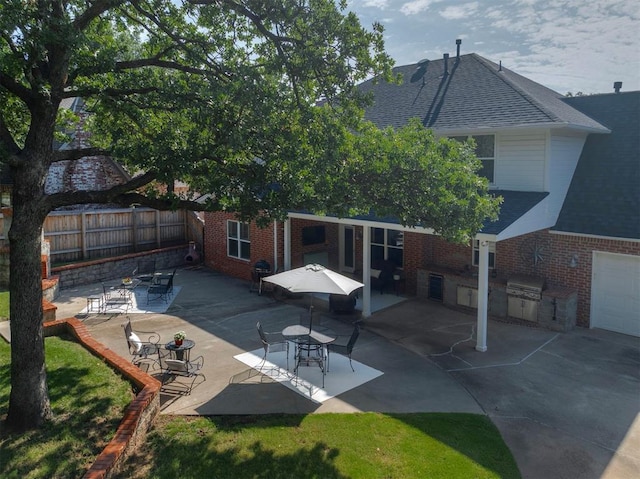 4201 Echohollow Trl, Edmond, OK 73025 - back of house featuring brick siding, roof with shingles, area for grilling, and a patio area