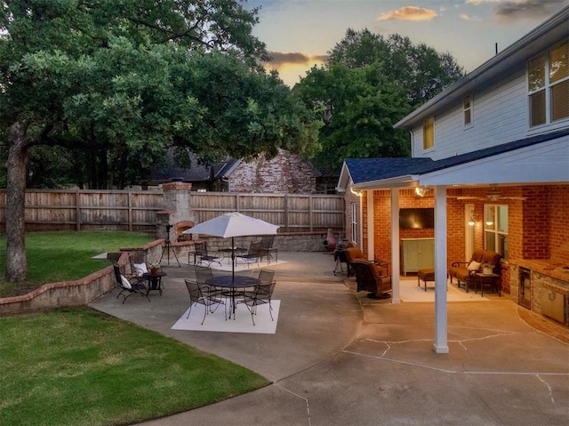 4201 Echohollow Trl, Edmond, OK 73025 - patio terrace at dusk with a fenced backyard, a patio area, and outdoor dining area